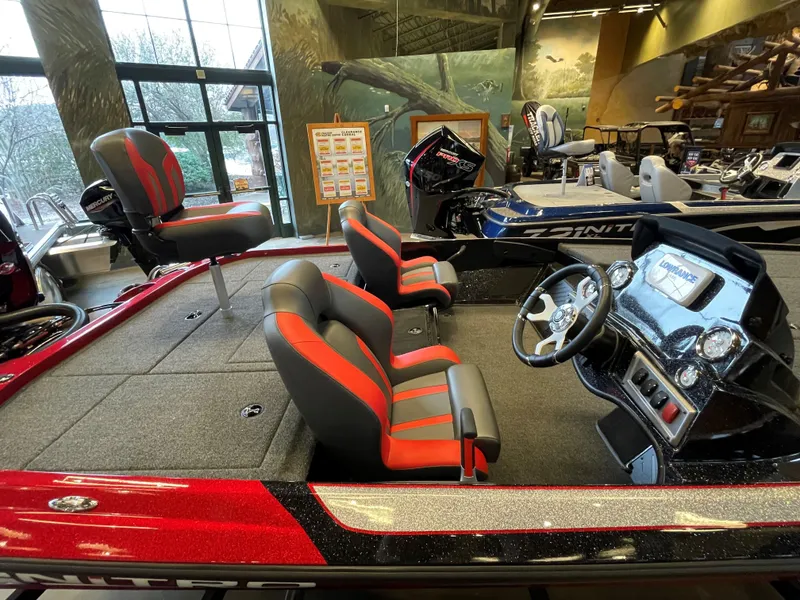 Slide: The Image of 2025 Nitro Z19 boat interior with red and black seating, steering console, and spacious deck. - 2