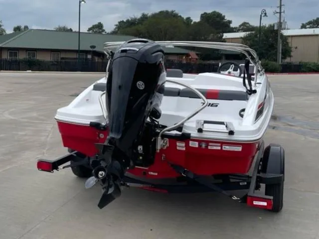 Slide: The Image of 2025 Tahoe T16 boat with outboard motor on trailer in parking lot. - 3