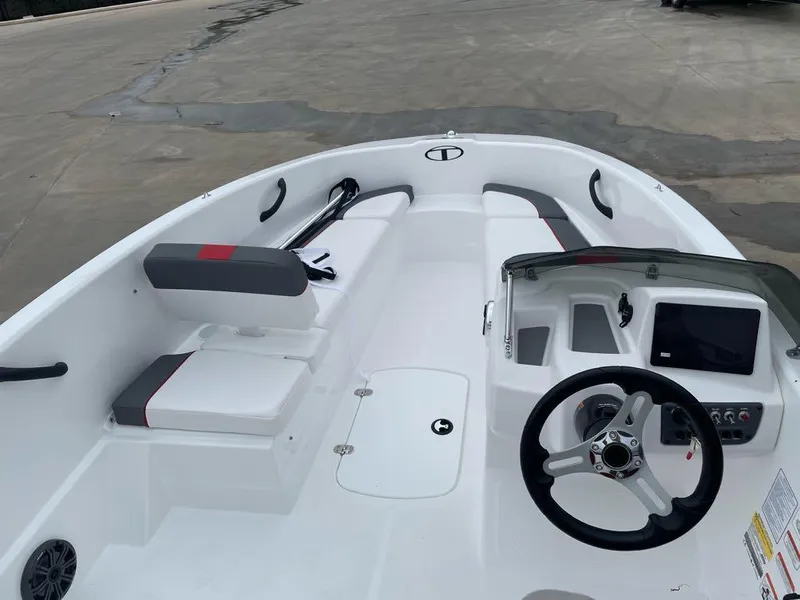 Slide: The Image of 2025 Tahoe T16 boat interior with steering wheel and seating. - 4