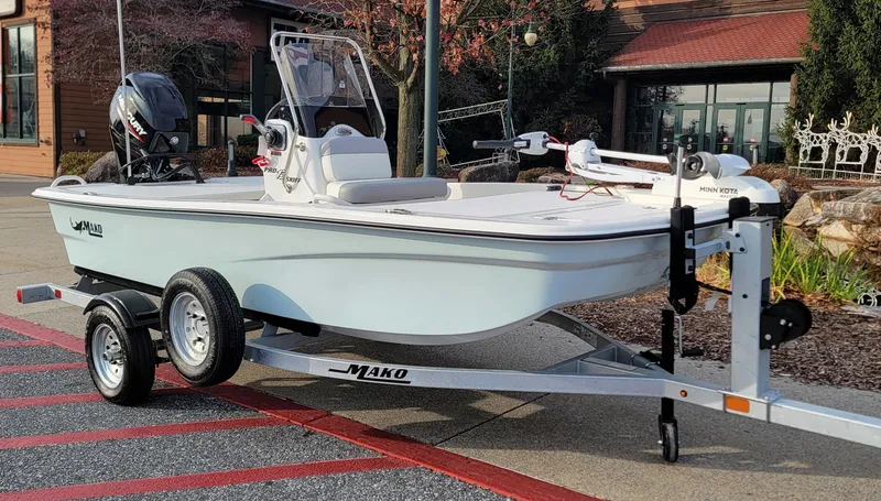 Slide: The Image of 2025 Mako Pro Skiff 13 CC boat on trailer, parked outdoors. - 1