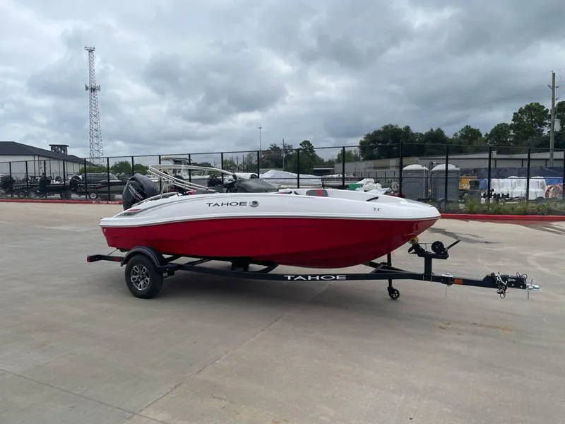 Slide: The Image of 2025 Tahoe T16 boat on trailer, red and white design, parked outdoors. - 1