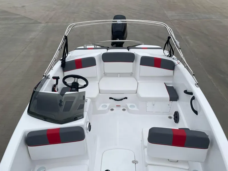 Slide: The Image of 2025 Tahoe T16 boat interior with red and gray seating, steering wheel, and windshield. - 4