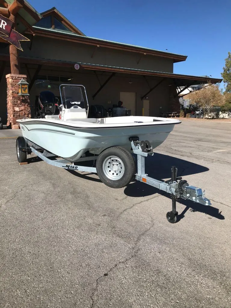 Slide: The Image of 2025 Mako Pro Skiff 17 CC boat on trailer in parking lot. - 2