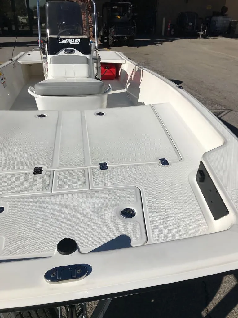 Slide: The Image of 2025 Mako Pro Skiff 17 CC boat, spacious deck, white finish, outdoor setting. - 5