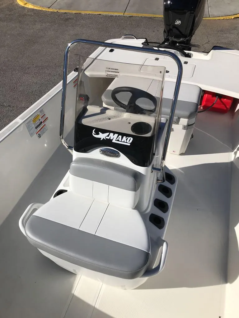 Slide: The Image of 2025 Mako Pro Skiff 17 CC boat interior with steering console and seating. - 6