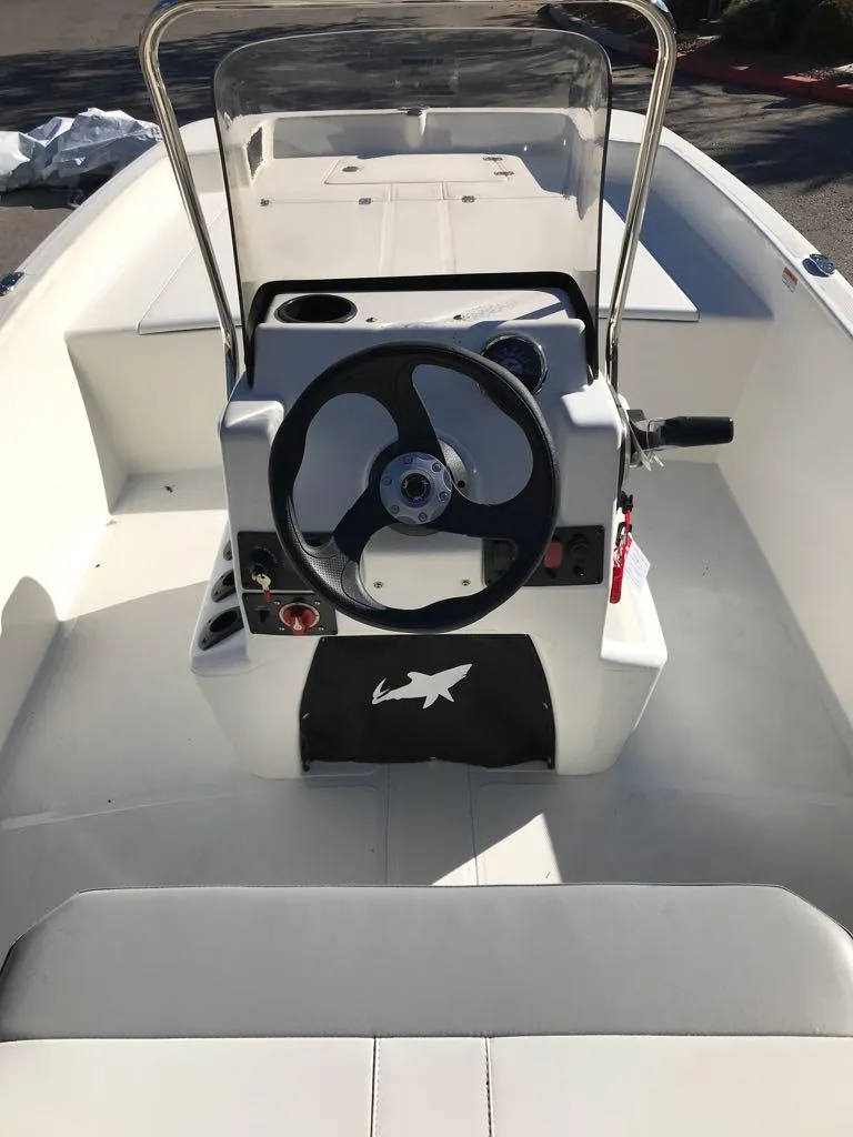 Slide: The Image of 2025 Mako Pro Skiff 17 CC boat interior with steering console and seating. - 9