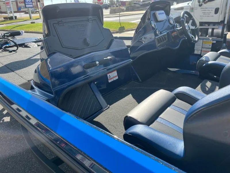 Slide: The Image of Interior of a 2025 Nitro Z18 boat with blue seating and dashboard. - 10