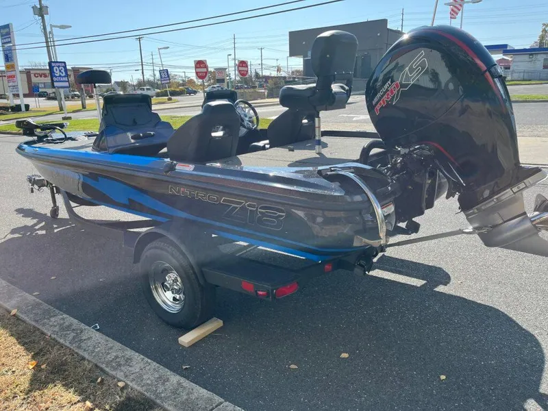 Slide: The Image of 2025 Nitro Z18 boat with powerful engine, parked outdoors in a commercial area. - 16
