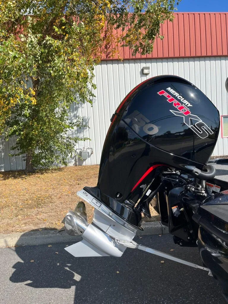 Slide: The Image of 2025 Nitro Z18 boat with Mercury Pro XS outboard motor in sunny outdoor setting. - 6