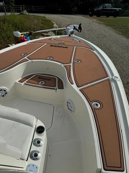 Slide: The Image of 2016 SeaVee 270Z boat with brown SeaDek flooring, parked on gravel. - 11