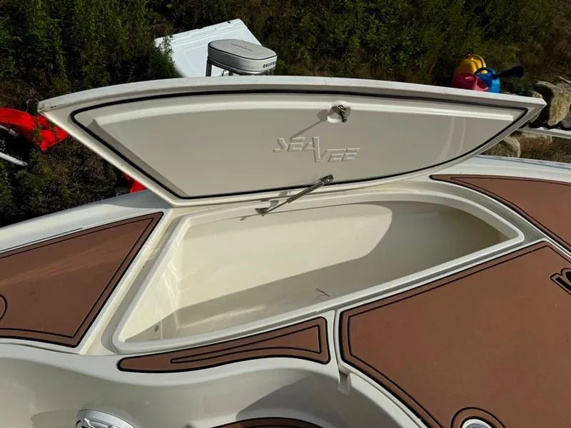 Slide: The Image of 2016 SeaVee 270Z boat storage compartment with open hatch, brown and white design. - 18