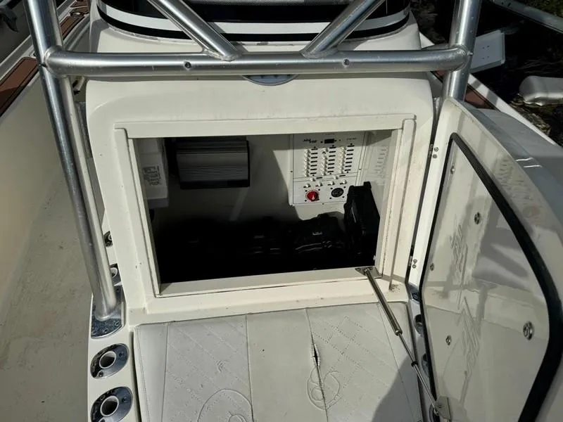 Slide: The Image of 2016 SeaVee 270Z boat console with open storage compartment and control panel. - 19