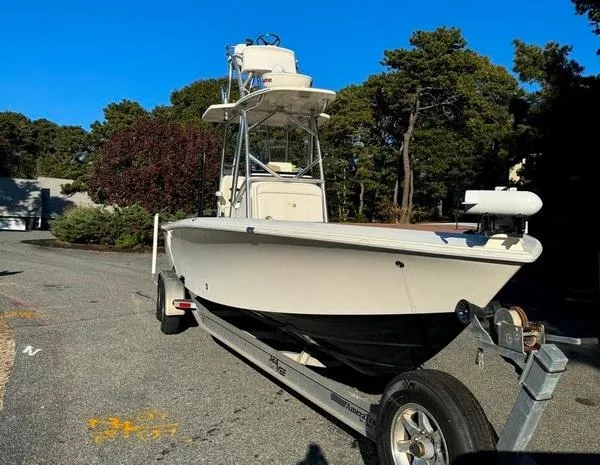 Slide: The Image of 2016 SeaVee 270Z boat on trailer, parked outdoors, surrounded by trees. - 2