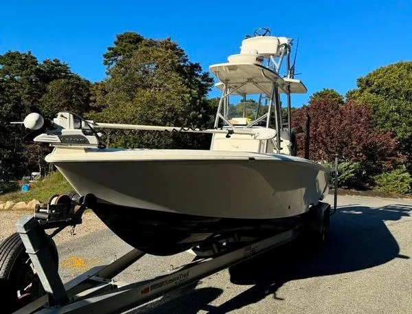 Slide: The Image of 2016 SeaVee 270Z boat on trailer, surrounded by trees under clear blue sky. - 4