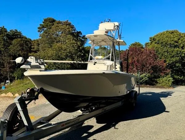 Slide: The Image of 2016 SeaVee 270Z boat on trailer, surrounded by trees under clear blue sky. - 7