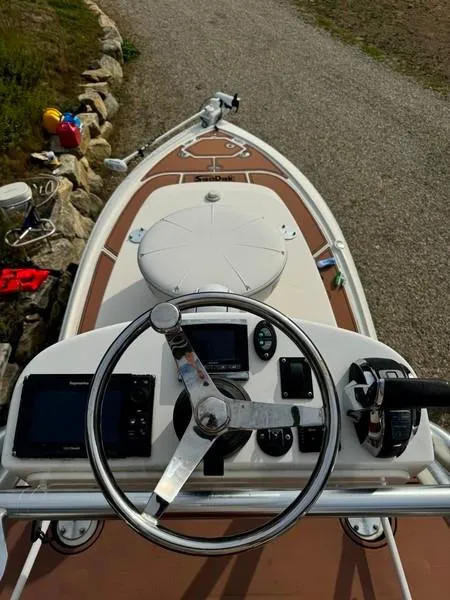 Slide: The Image of 2016 SeaVee 270Z boat helm with steering wheel and navigation controls. - 9