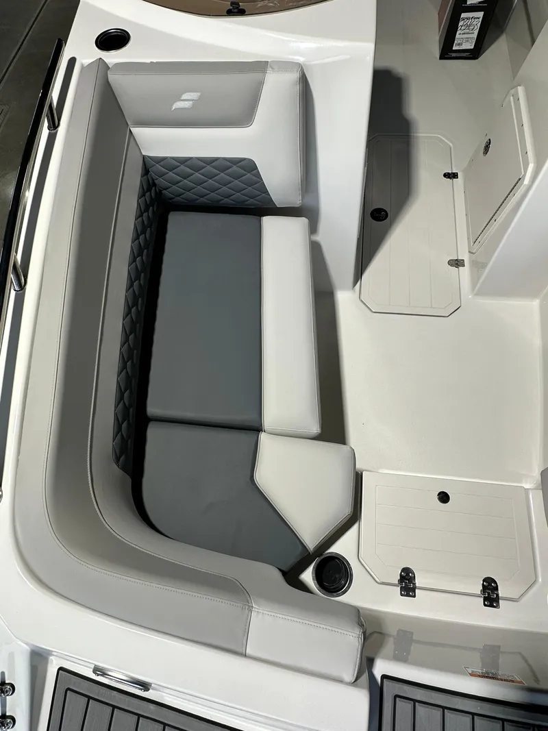 Slide: The Image of 2025 Starcraft SVX 211 IO boat interior with gray and white cushioned seating. - 4