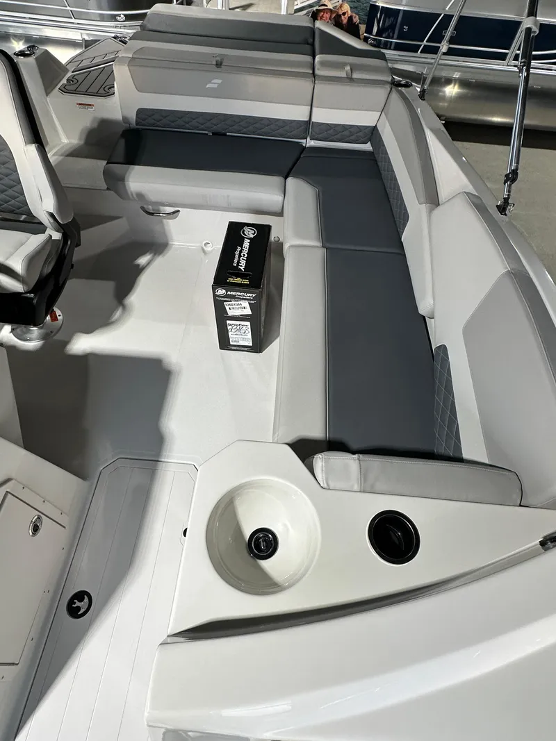 Slide: The Image of 2025 Starcraft SVX 211 IO boat interior with gray seating and cup holder. - 6