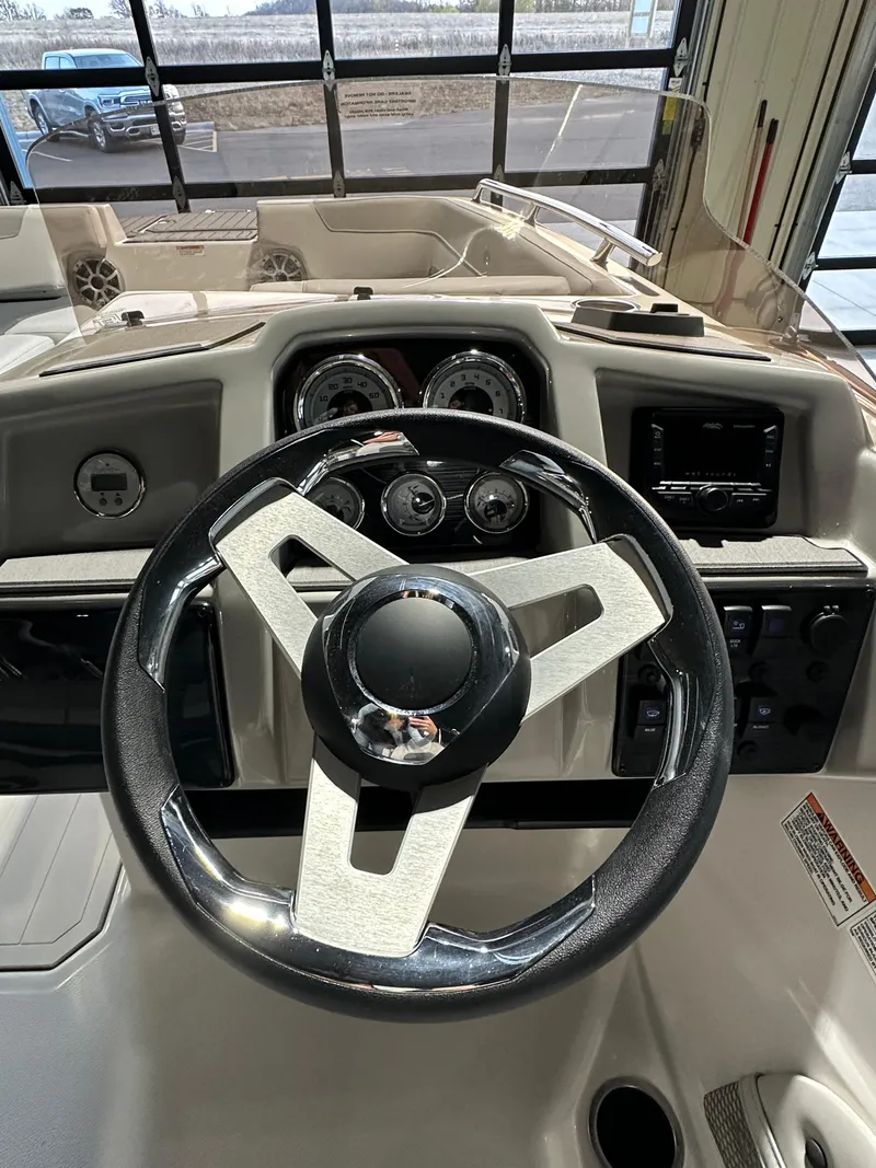 Slide: The Image of 2025 Starcraft SVX 211 IO boat dashboard with steering wheel and gauges. - 9