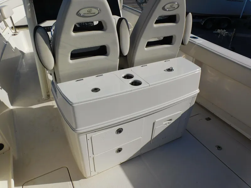 Slide: The Image of 2023 Sailfish 290 CC boat interior with dual seats and storage console. - 13