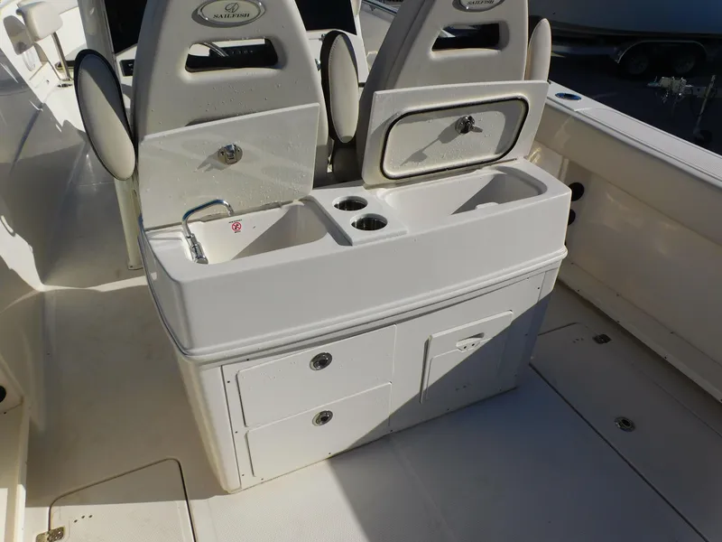 Slide: The Image of 2023 Sailfish 290 CC boat interior with dual seats and storage compartments. - 14