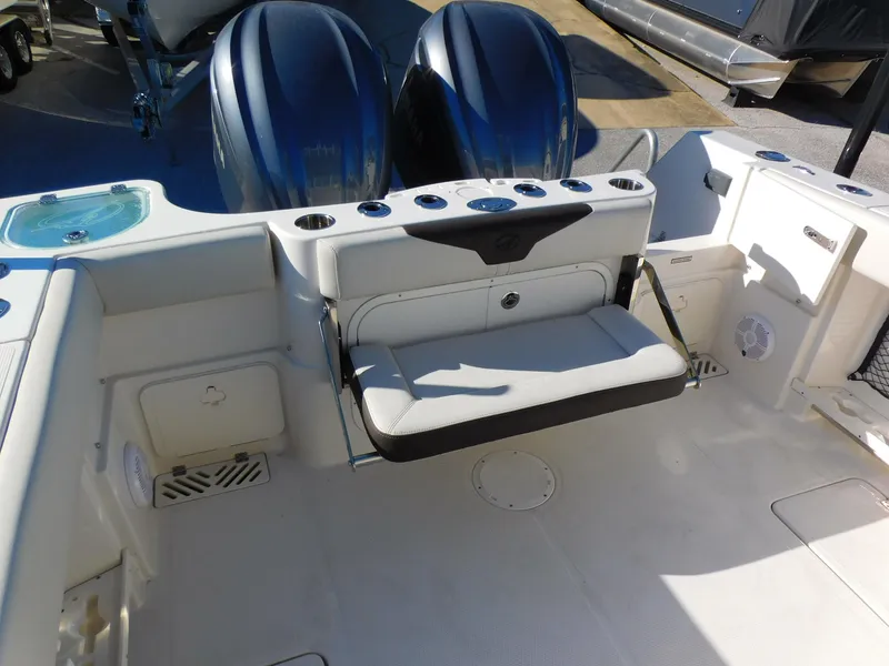 Slide: The Image of 2023 Sailfish 290 CC boat interior with dual engines and foldable seat. - 15