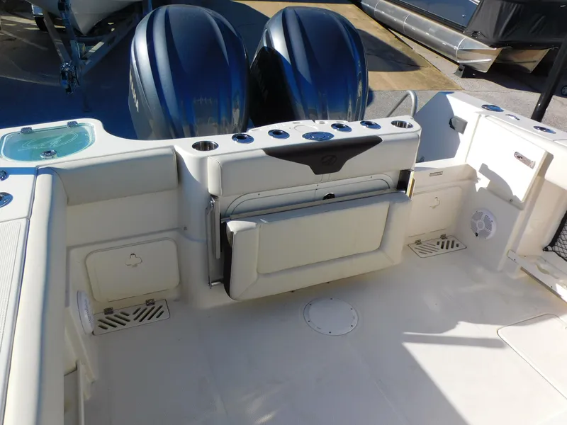 Slide: The Image of 2023 Sailfish 290 CC boat interior with dual engines and seating area. - 16