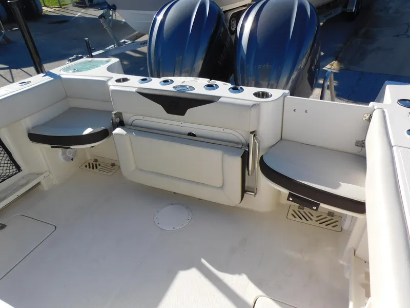 Slide: The Image of 2023 Sailfish 290 CC boat interior with seating and dual engines. - 17