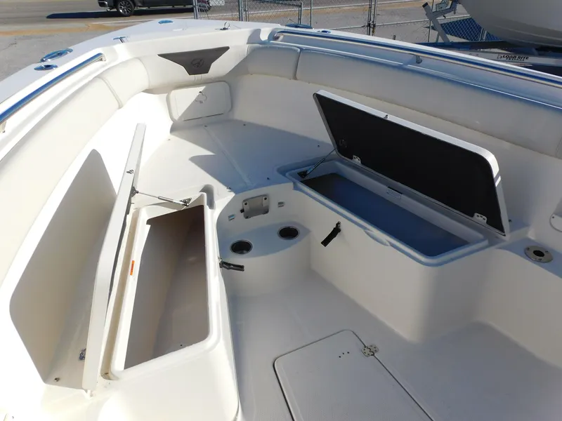 Slide: The Image of 2023 Sailfish 290 CC boat interior with open storage compartments. - 20