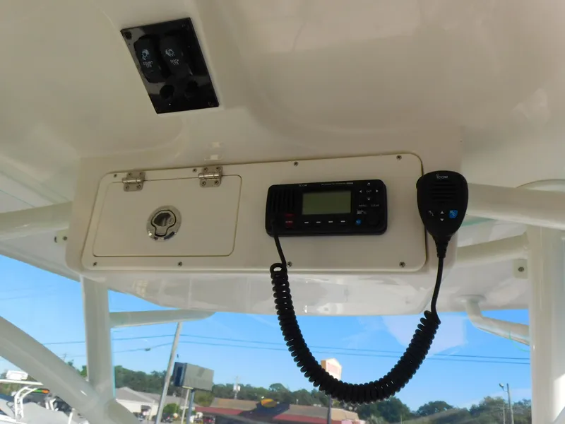 Slide: The Image of 2023 Sailfish 290 CC boat console with radio and storage compartment. - 25