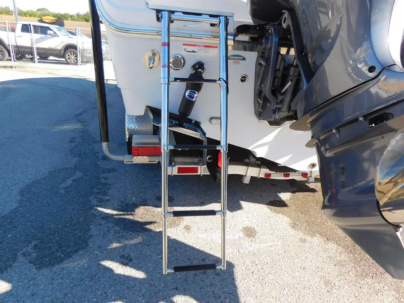 Slide: The Image of Sailfish 290 CC 2023 boat ladder and engine detail in sunlight. - 5