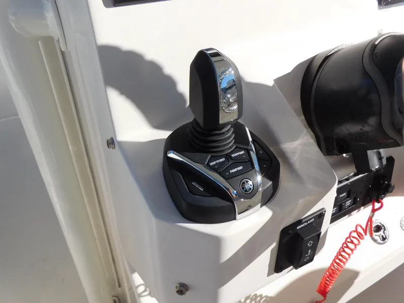 Slide: The Image of 2023 Sailfish 290 CC boat control panel with joystick and buttons. - 7