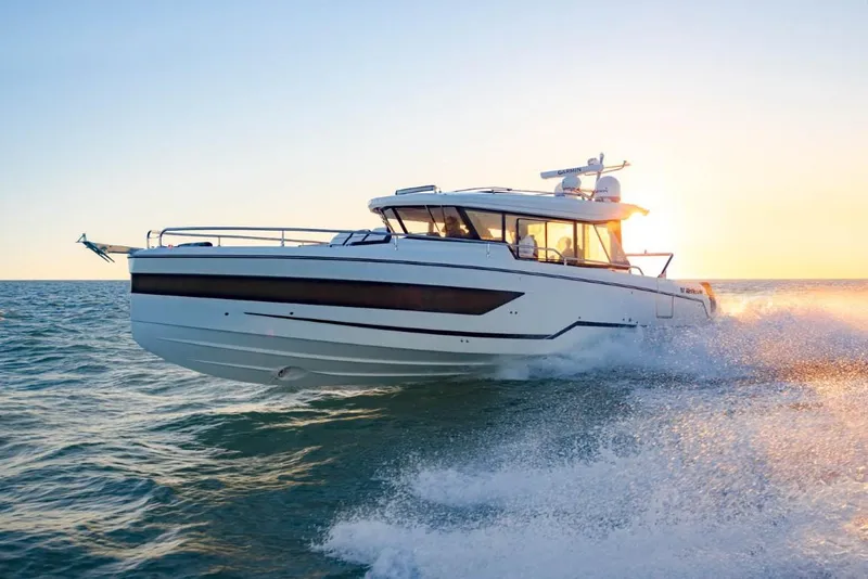 The Image of 2025 Wellcraft 38 Explorer yacht cruising at sunset on open water. - 0