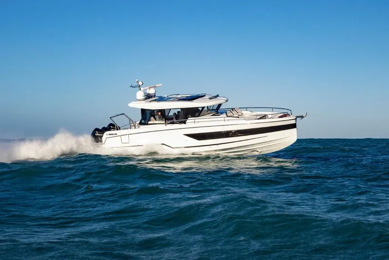 Slide: The Image of 2025 Wellcraft 38 Explorer cruising on open sea under clear blue sky. - 1