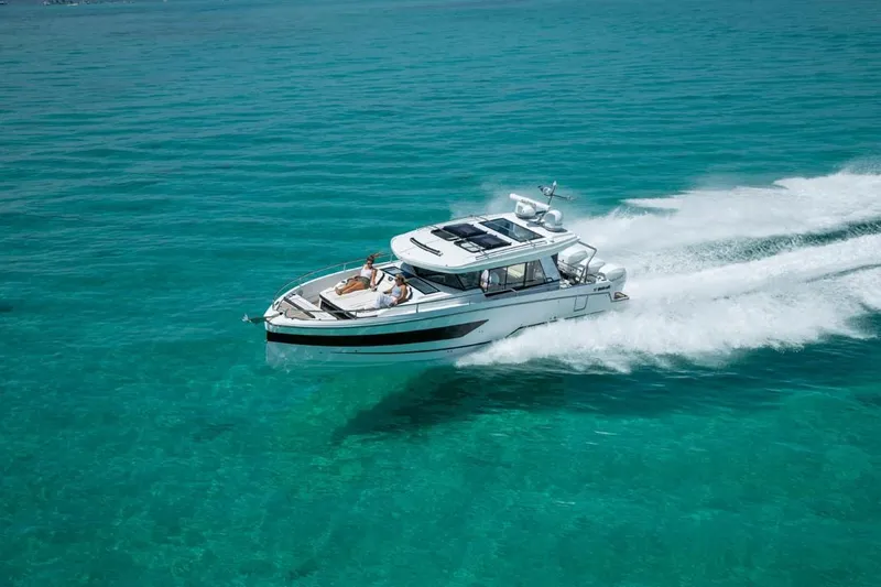 Slide: The Image of 2025 Wellcraft 38 Explorer cruising on clear turquoise waters. - 4