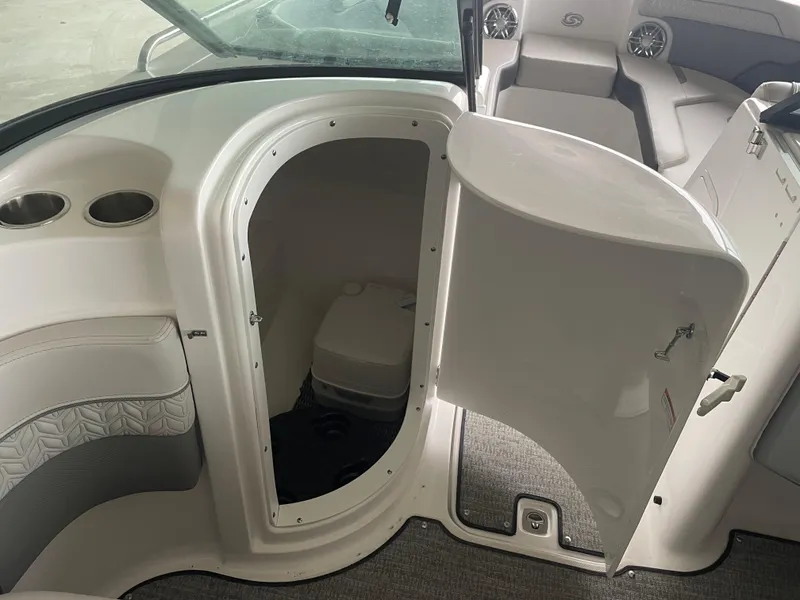 Slide: The Image of 2022 Hurricane SunDeck 2200 DC OB boat interior with open storage compartment. - 11