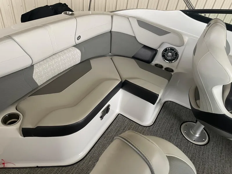 Slide: The Image of 2022 Hurricane SunDeck 2200 DC OB boat interior with cushioned seating and cup holders. - 12