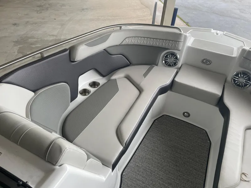 Slide: The Image of 2022 Hurricane SunDeck 2200 DC OB boat interior with cushioned seating and cup holders. - 16