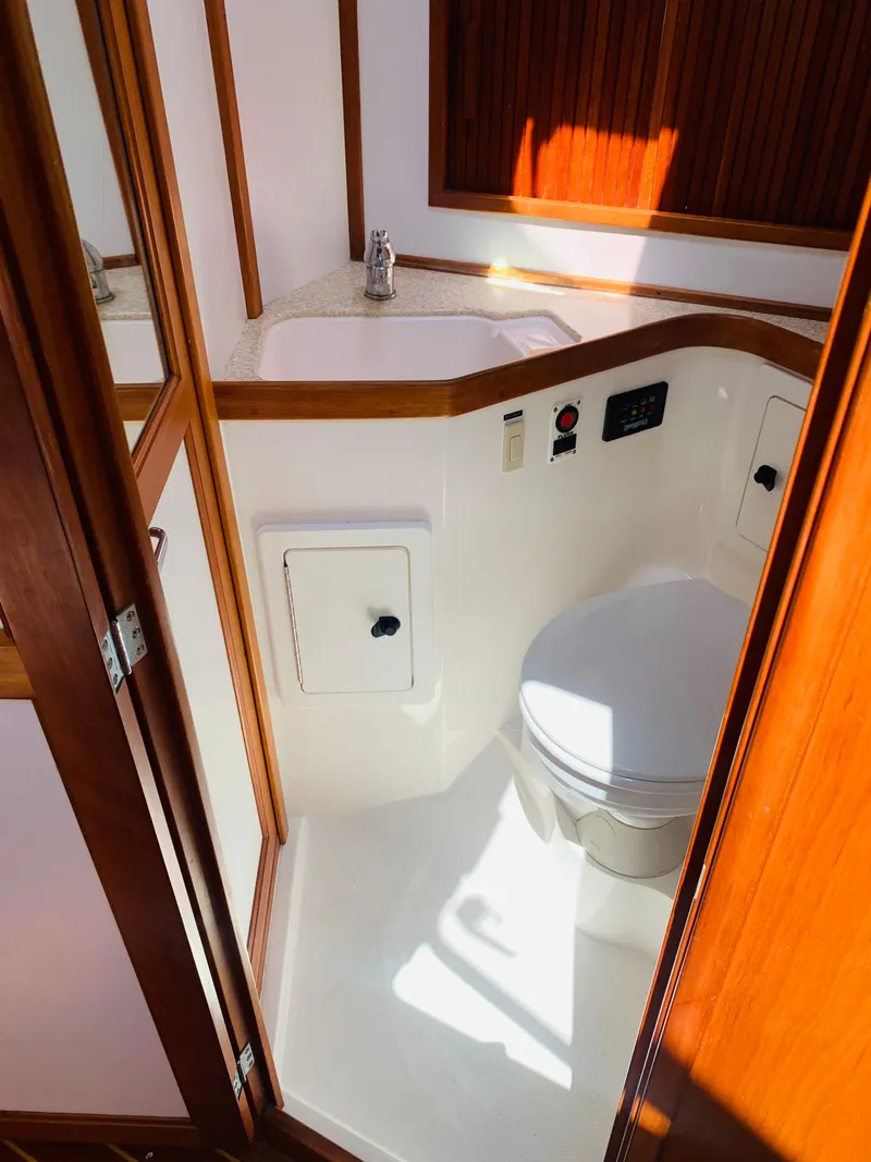 Slide: The Image of 2004 Sabre 42 Hardtop Express yacht bathroom with sink and toilet. - 16