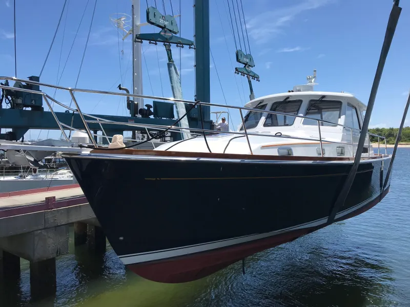 Slide: The Image of 2004 Sabre 42 Hardtop Express yacht being lifted from water. - 2