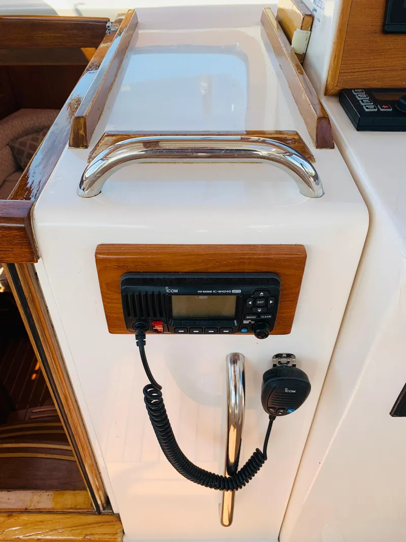 Slide: The Image of 2004 Sabre 42 Hardtop Express yacht interior with radio and wooden accents. - 22