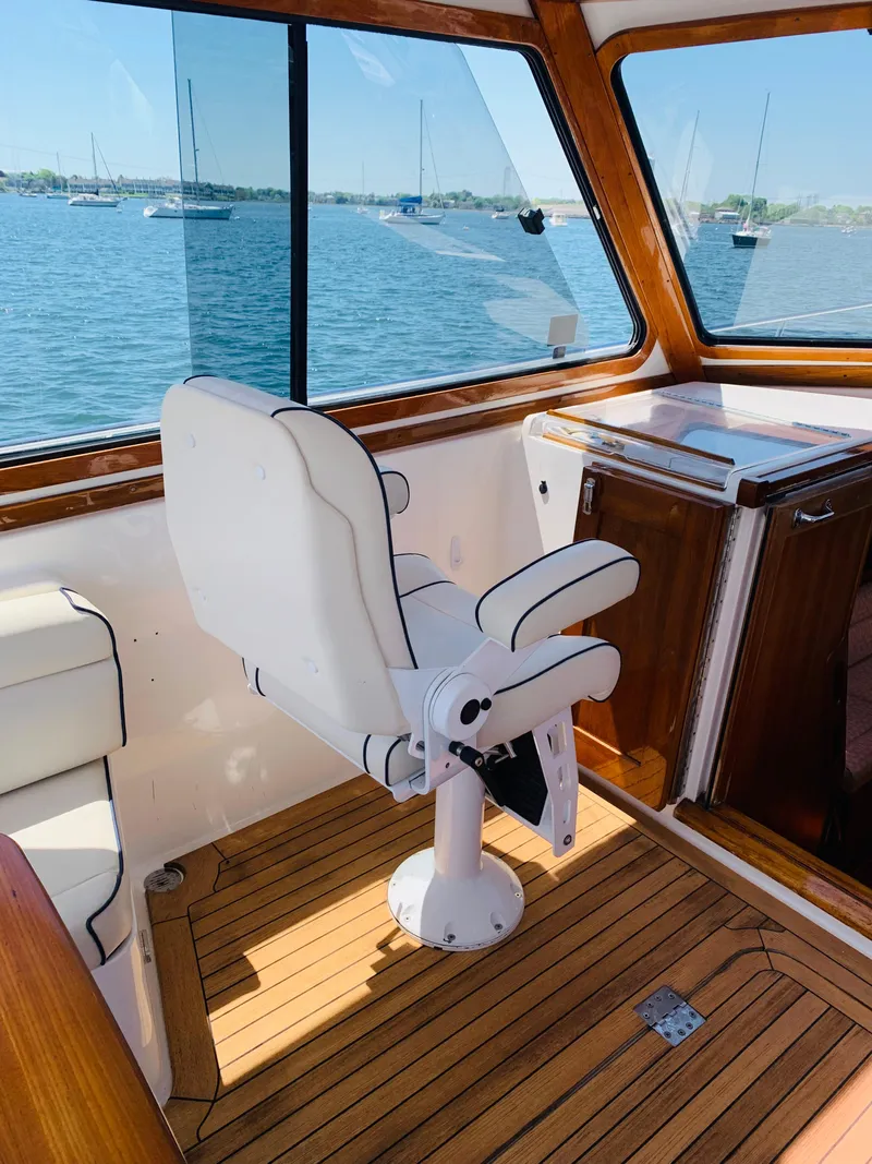 Slide: The Image of 2004 Sabre 42 Hardtop Express interior with captain's chair and scenic water view. - 25