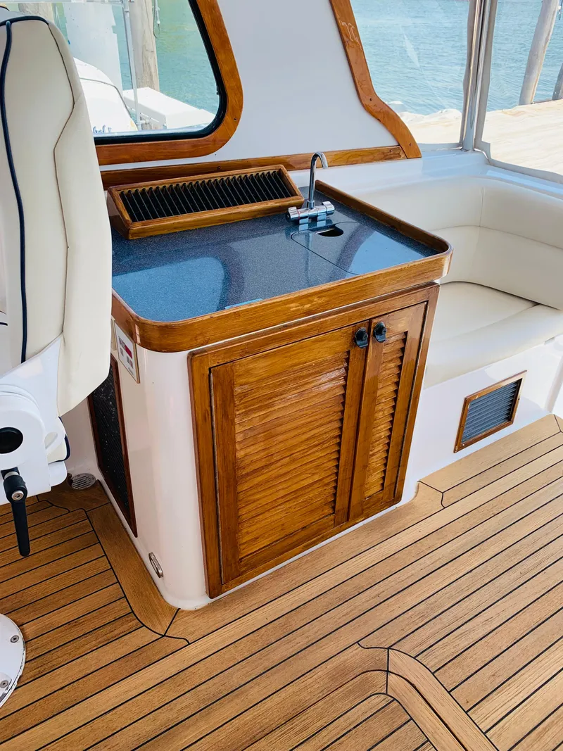 Slide: The Image of 2004 Sabre 42 Hardtop Express interior with wooden cabinetry and seating. - 27