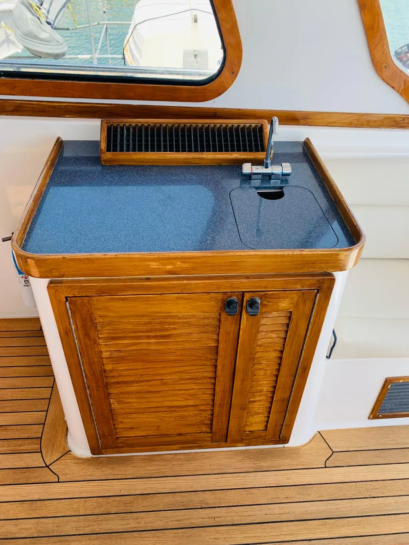 Slide: The Image of 2004 Sabre 42 Hardtop Express yacht interior with wooden cabinetry and sink. - 28