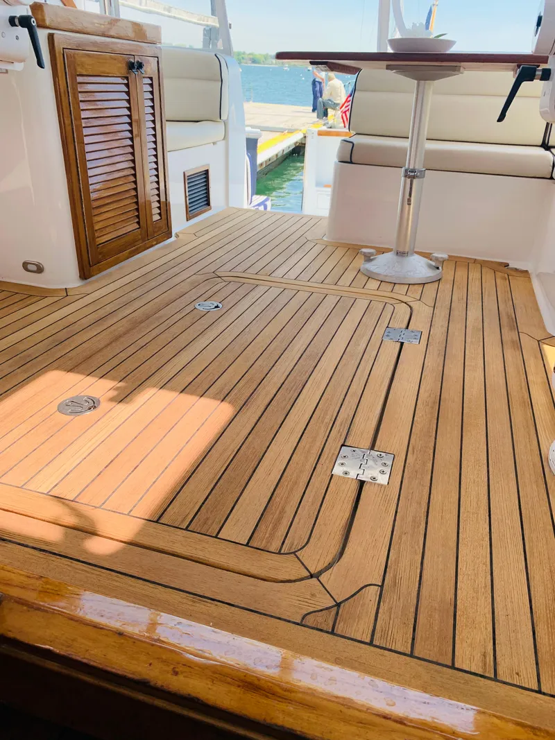 Slide: The Image of Teak deck of 2004 Sabre 42 Hardtop Express yacht with seating and table. - 31