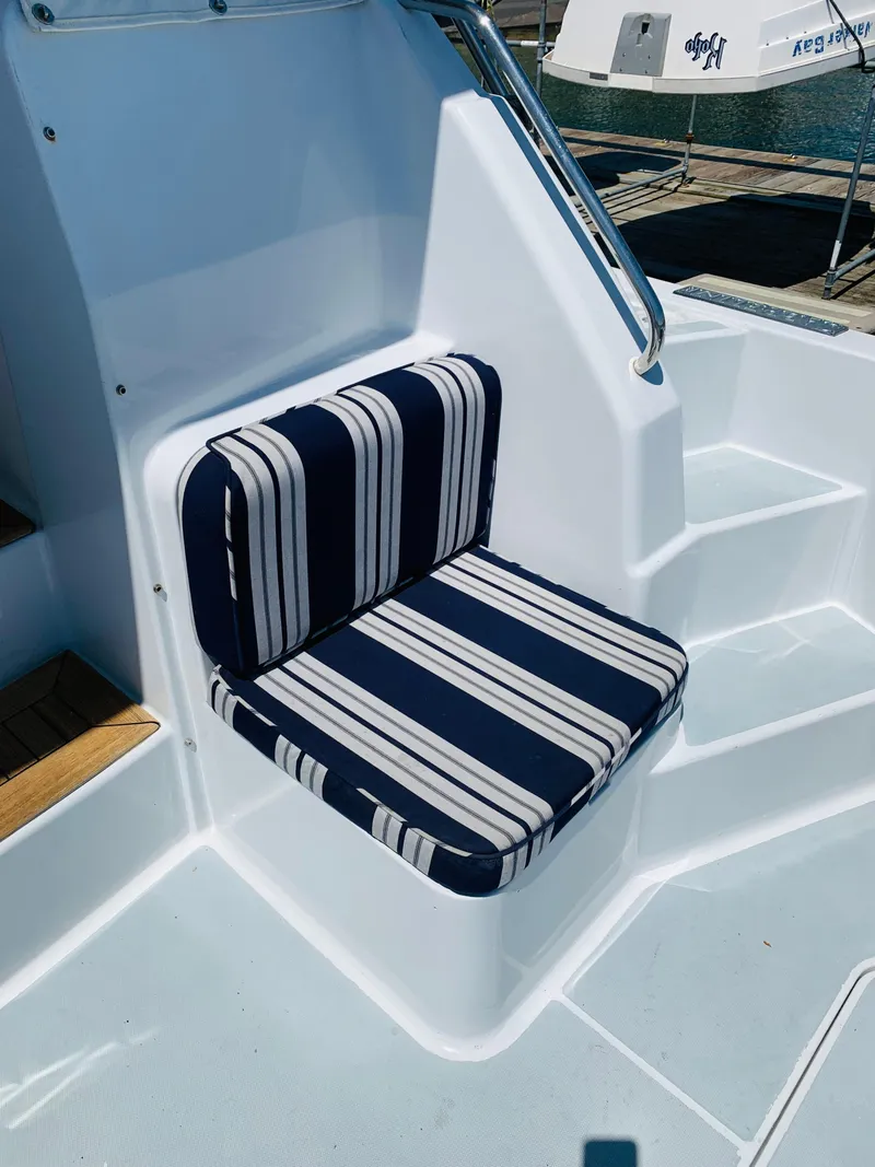 Slide: The Image of Striped seat cushion on 2004 Sabre 42 Hardtop Express boat deck. - 33