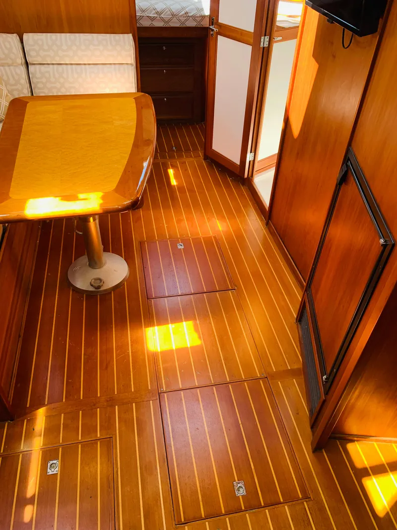 Slide: The Image of Interior of 2004 Sabre 42 Hardtop Express with polished wood flooring and table. - 4