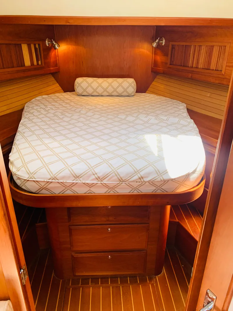 Slide: The Image of 2004 Sabre 42 Hardtop Express cabin with cozy bed and wooden interior. - 5