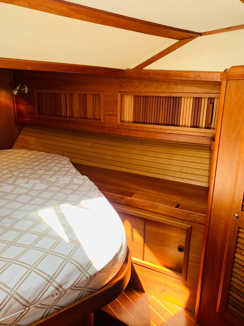 Slide: The Image of 2004 Sabre 42 Hardtop Express cabin interior with wooden finish and bed. - 7