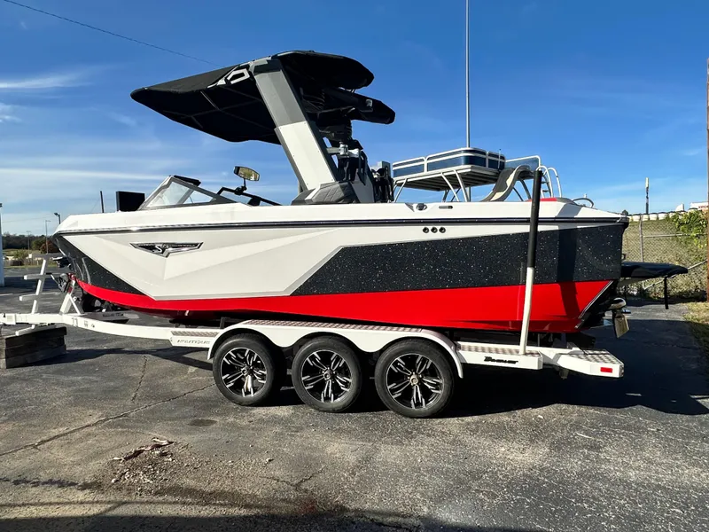 Slide: The Image of 2022 Nautique S23 boat on trailer, featuring sleek design and vibrant red accents. - 4